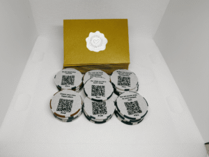 Set of 25 Share This Forward Kindness Tokens with uplifting messages and QR codes, each paired with a shimmering golden envelope sealed by a silver heart sticker — designed to inspire kindness and track its journey as it’s shared forward